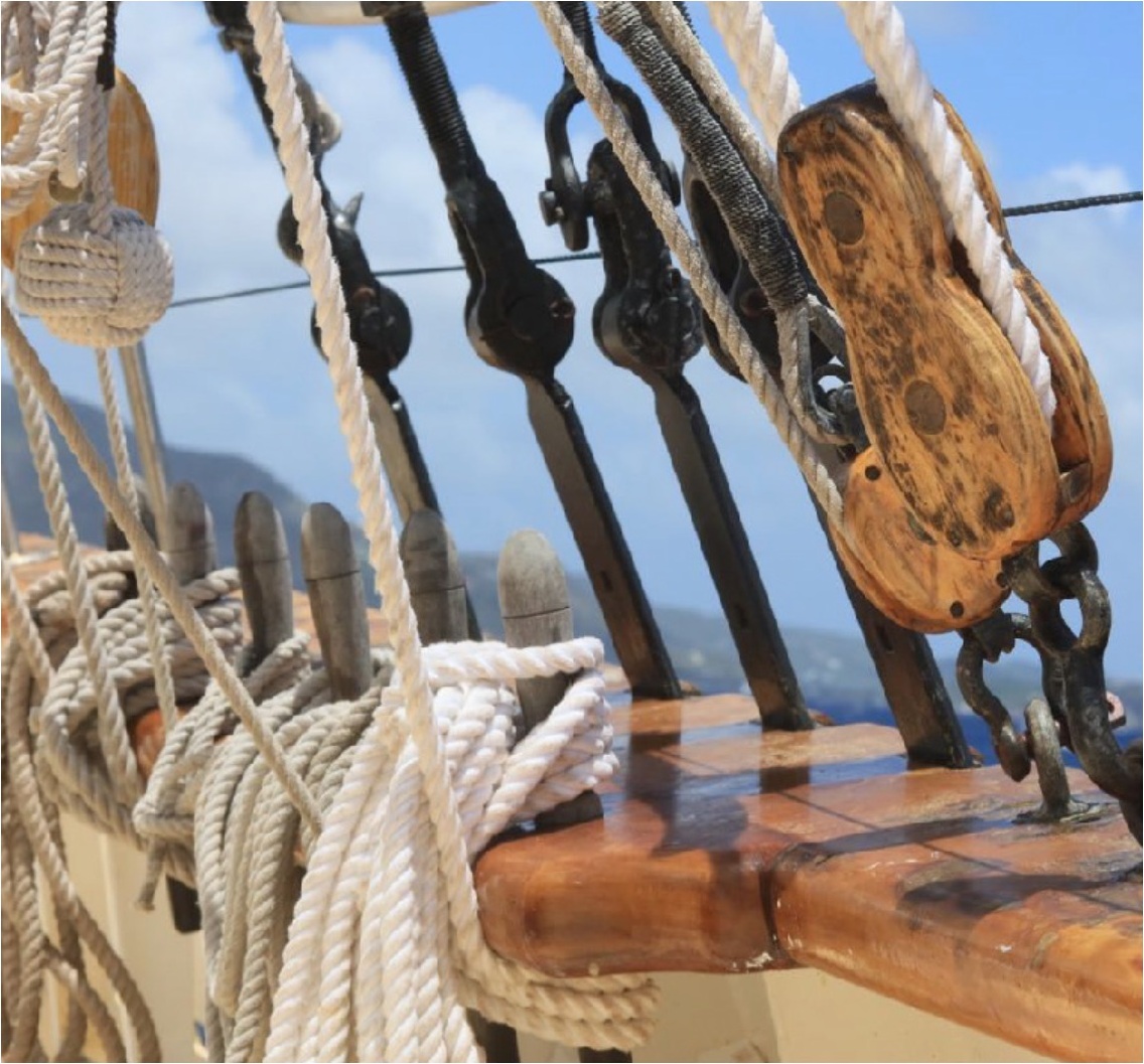 Ropes, wooden blocks and wood rail aboard the schooner RUTH